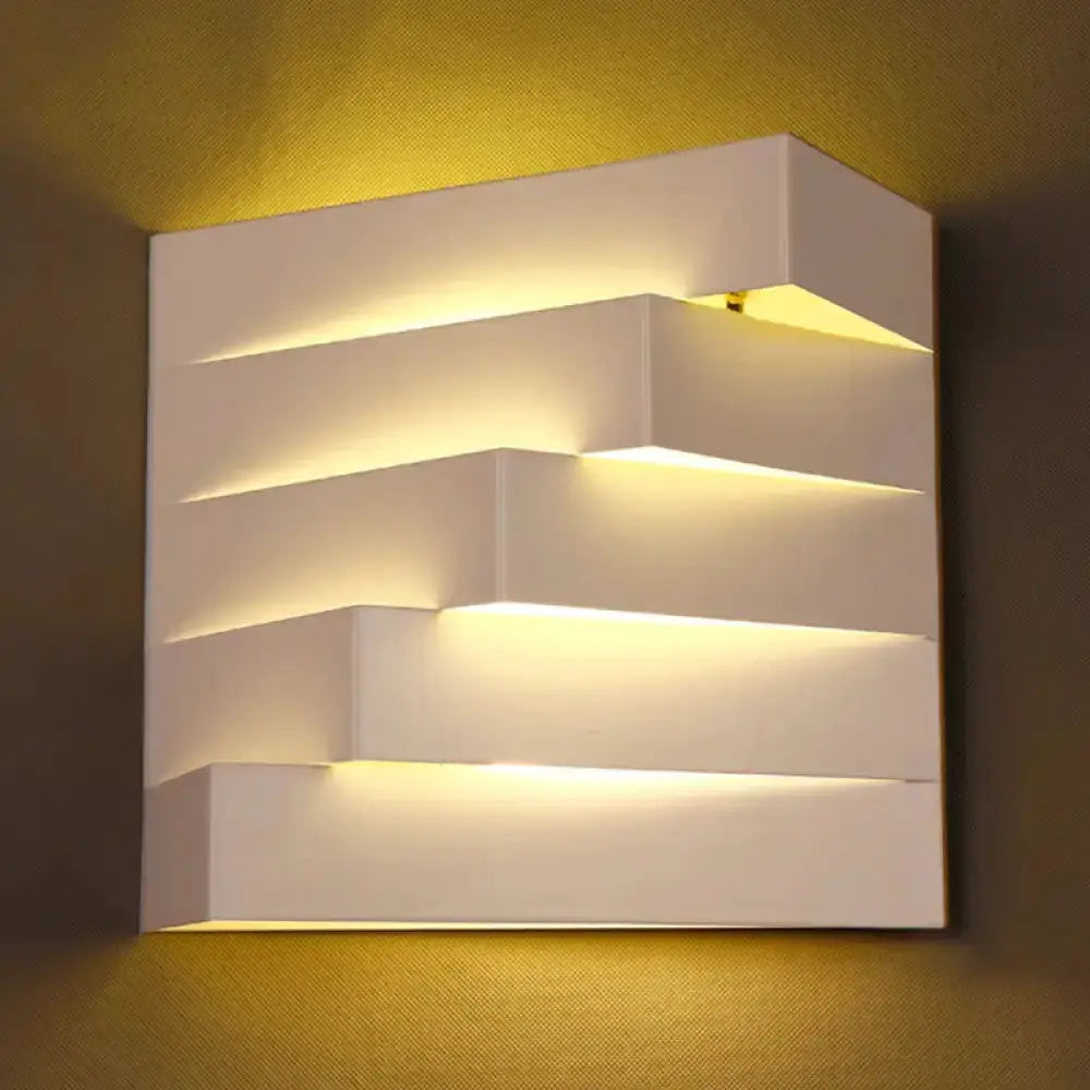 Modern white geometric wall sconce by Decorbites with layered panels and warm LED glow on Tampa Home & Garden Store