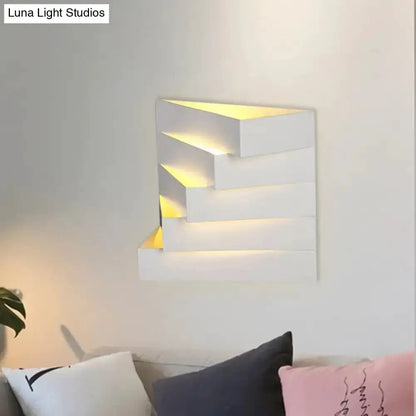 Modern white geometric wall sconce with layered rectangular panels and warm backlight on Tampa Home & Garden Store
