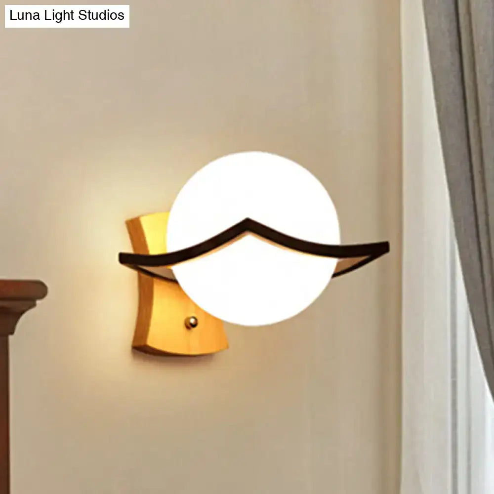 White glass ball sconce with black curved accent for wall mounting decor on Tampa Home & Garden Store