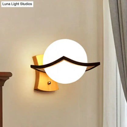 White glass ball sconce with black curved accent for wall mounting decor on Tampa Home & Garden Store