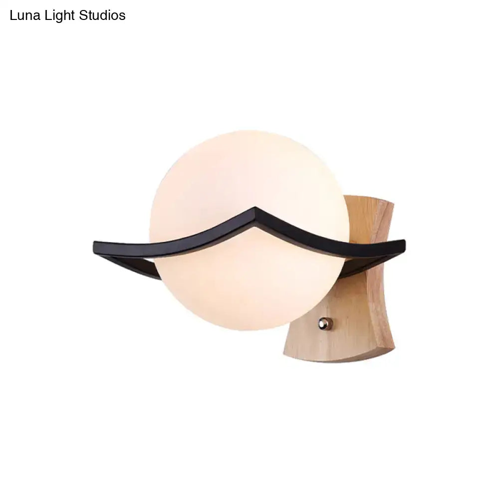 White glass ball sconce with black curved accent on wooden mount Decorbites on Tampa Home & Garden Store