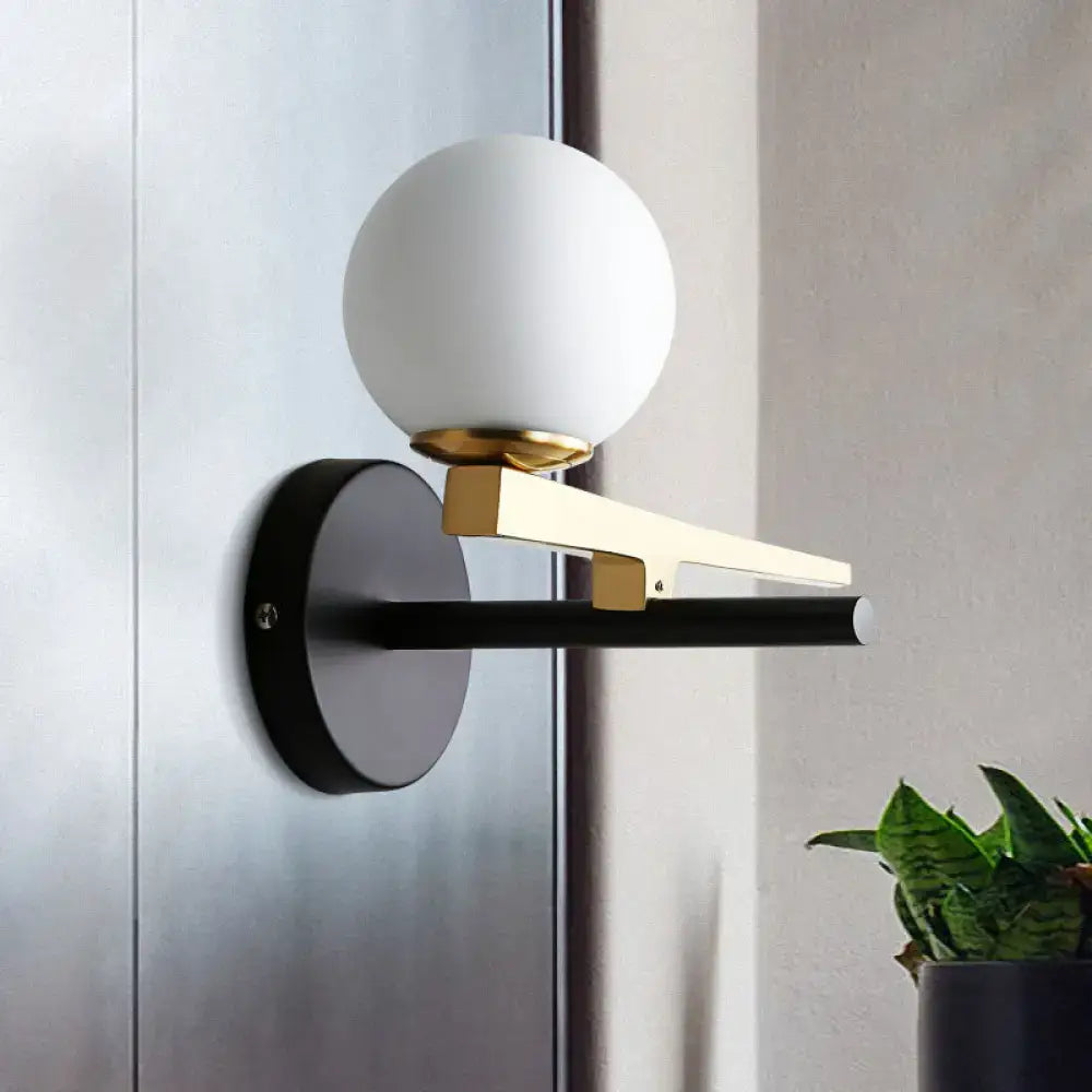 Gold Glass Sphere Wall Light sconce with frosted globe, gold arm, black backplate by Decorbites on Tampa Home & Garden Store