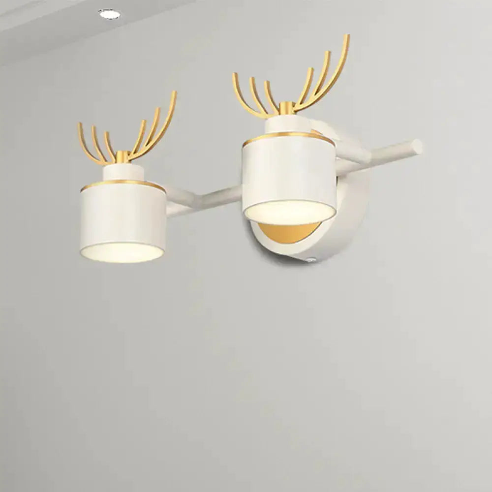 Antler-style white and gold bathroom vanity wall light with dual cylindrical LED shades on Tampa Home & Garden Store