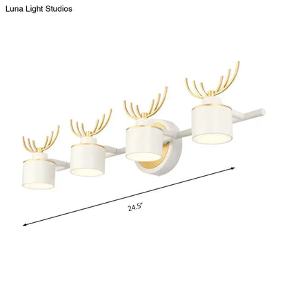 Modern white and gold antler wall light fixture with four cylindrical LED shades on Tampa Home & Garden Store