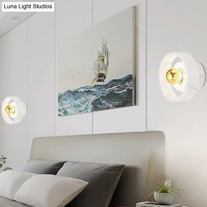 White Gold Wall Sconce pair with round white mounts and gold centers flanking a bed on Tampa Home & Garden Store