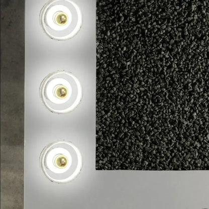 White Gold Wall Sconce by Decorbites with three circular LED rings and brass centers on a panel on Tampa Home & Garden Store