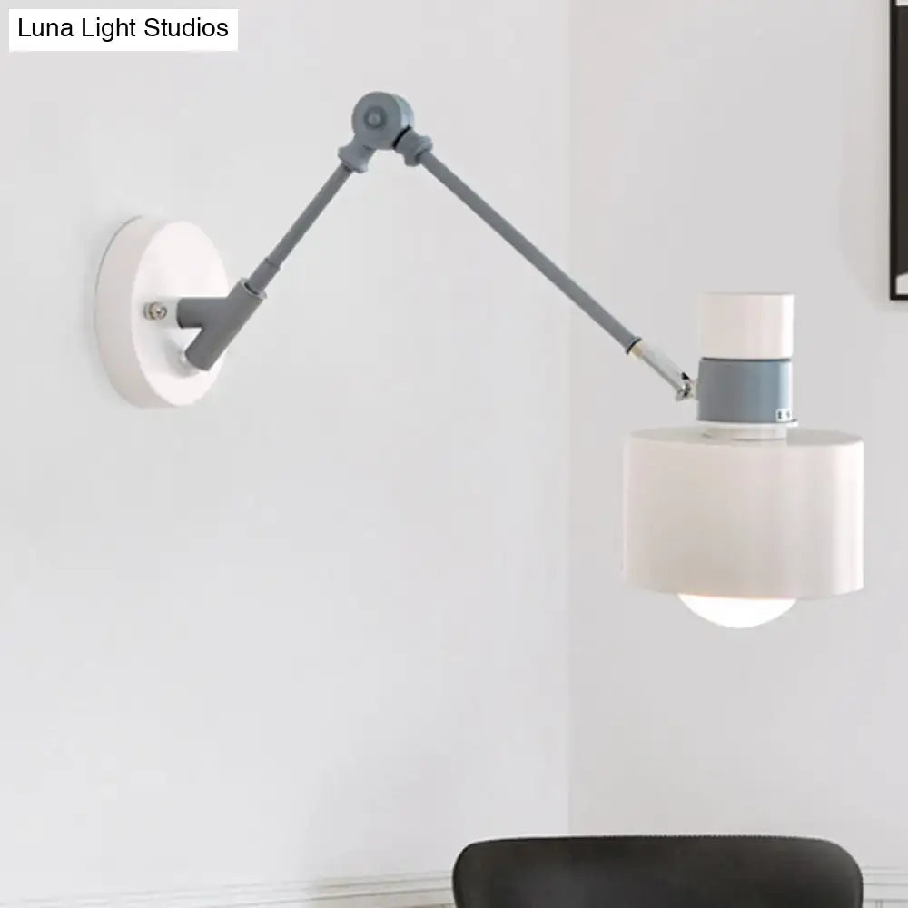 Gray adjustable wall sconce with a hinged metal arm and white drum shade on Tampa Home & Garden Store