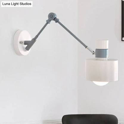Gray adjustable wall sconce with a hinged metal arm and white drum shade on Tampa Home & Garden Store