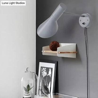 White rotating wall sconce by Decorbites with adjustable head, mounted on a gray wall on Tampa Home & Garden Store