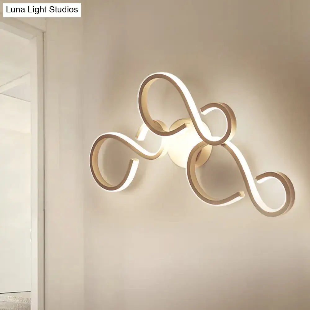 White infinity spiral wall light with looping LED tubes, wall-mounted Decorbites lamp with Luna Light Studios watermark on Tampa Home & Garden Store