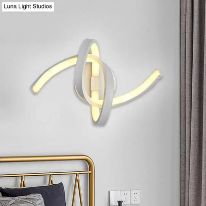 White knotted linear wall sconce with interlocking loops and warm LED glow on Tampa Home & Garden Store