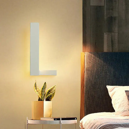 White L-Shaped Wall Sconce by Decorbites, modern matte finish with warm glow in bedroom on Tampa Home & Garden Store