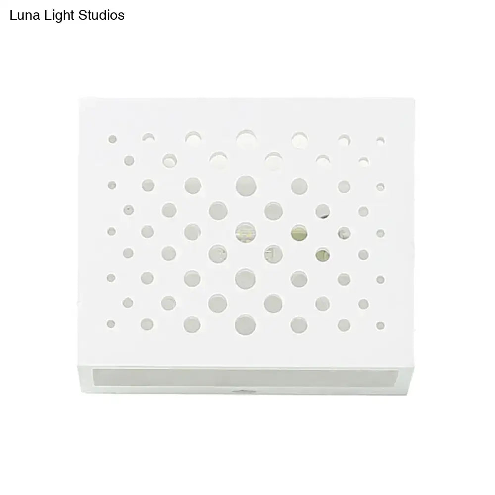 White laser-cut gypsum cube sconce with circular perforations by Decorbites on Tampa Home & Garden Store