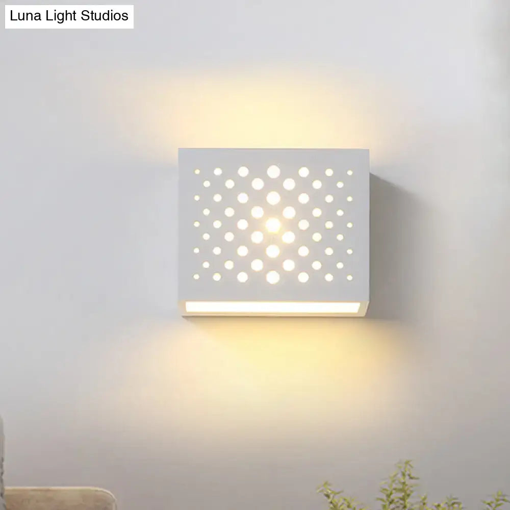 White gypsum cube sconce with perforated dot pattern by Decorbites emits warm ambient light on Tampa Home & Garden Store