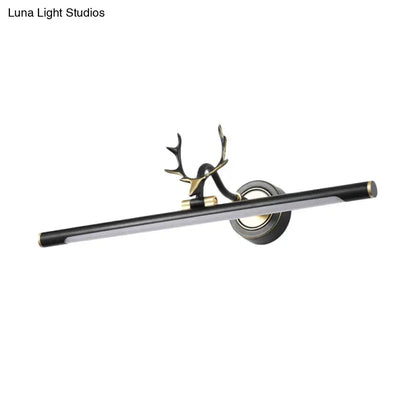 Black metal straight shade vanity light with gold end caps and a deer antler mount on Tampa Home & Garden Store