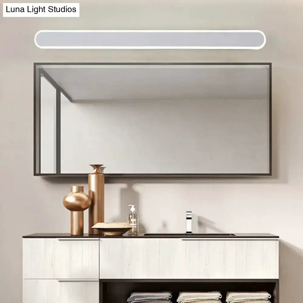 Modern white LED wall light bathroom mirror fixture above a vanity with copper decor accents on Tampa Home & Garden Store