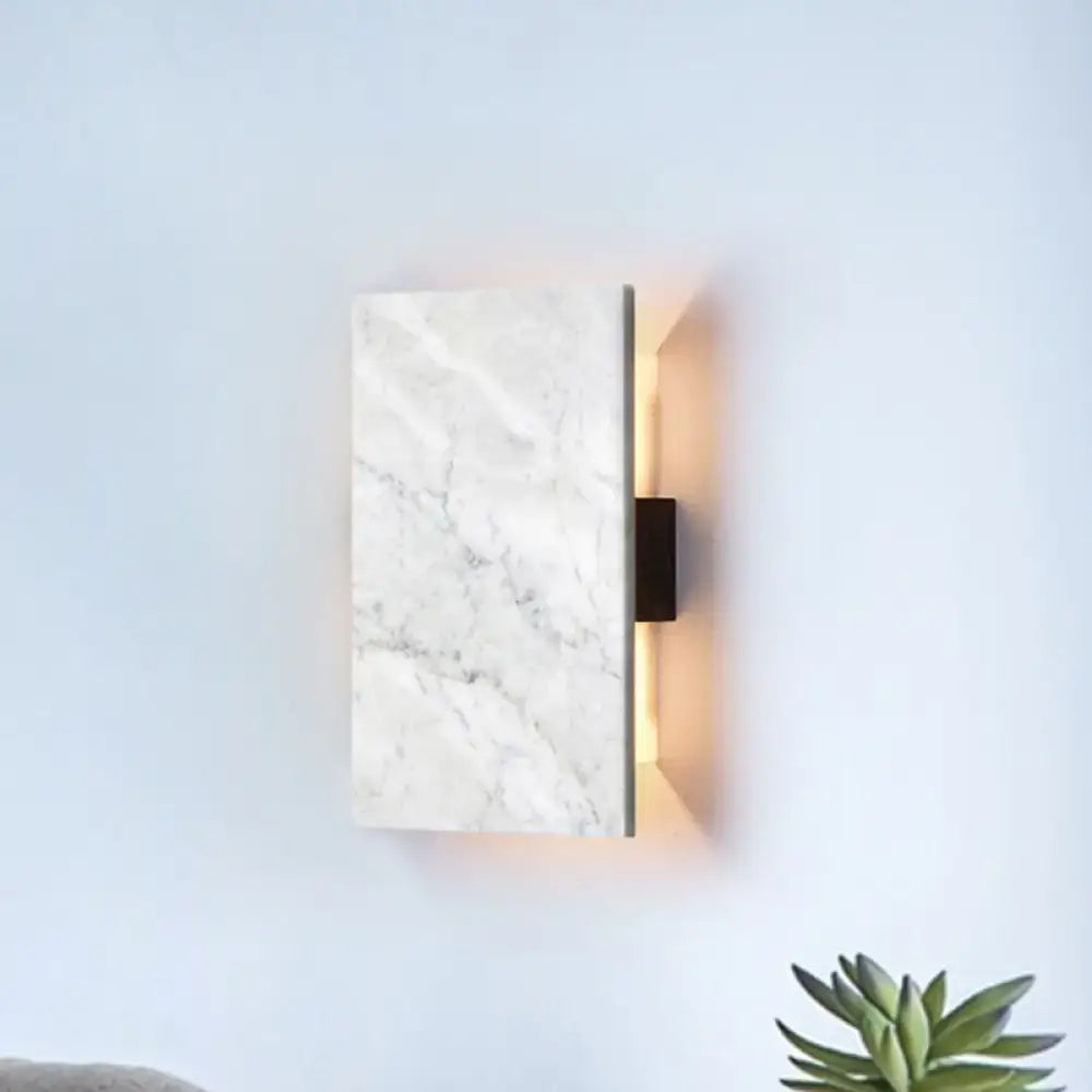 Marble Black Refined Wall Sconce with white marble face and black mounting, warm backlit glow on Tampa Home & Garden Store