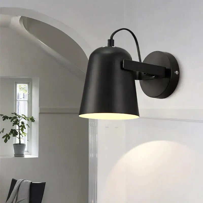 Black matte adjustable wall sconce with rotating arm and conical shade by Decorbites on Tampa Home & Garden Store