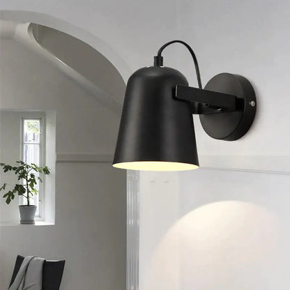 Black matte adjustable wall sconce with rotating arm and conical shade by Decorbites on Tampa Home & Garden Store