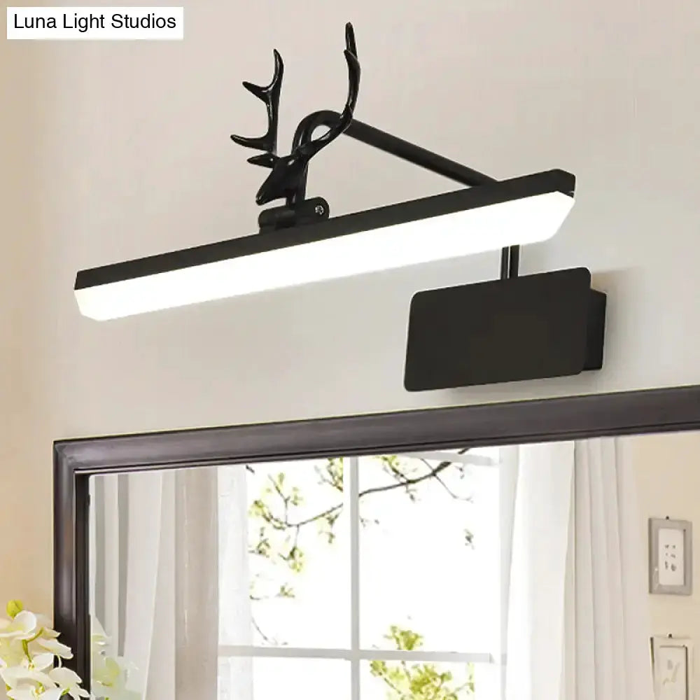 Modern white metal antler vanity wall lamp with black mount above bathroom mirror on Tampa Home & Garden Store