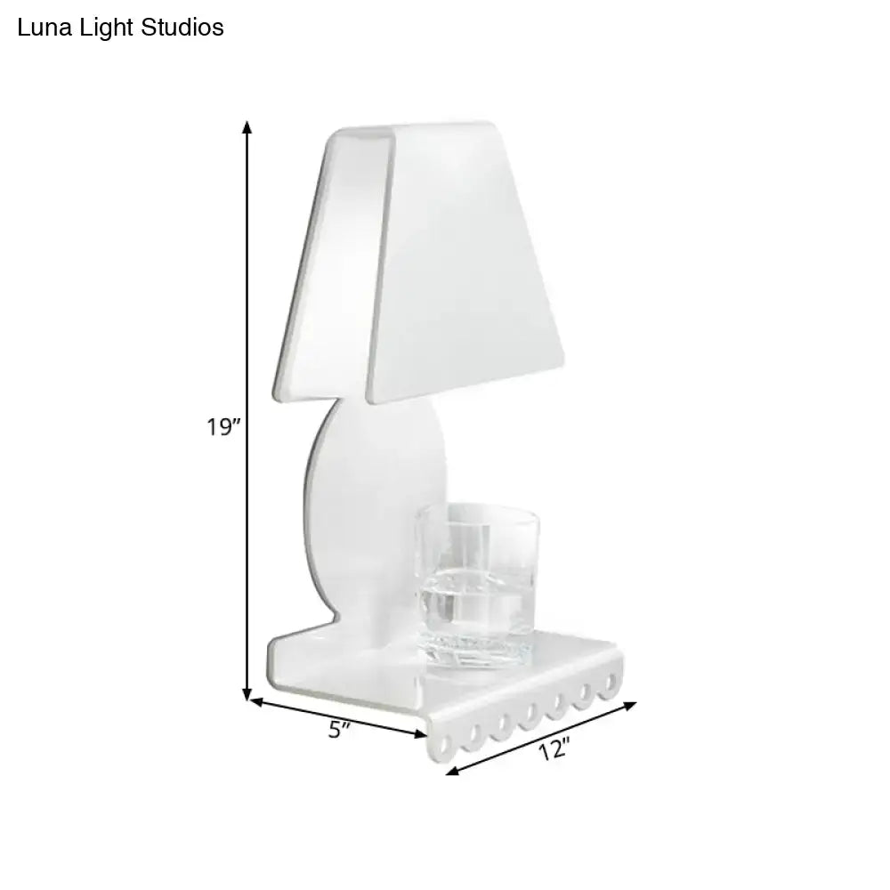 White trapezoid wall sconce with curved pedestal and glass tumbler on base on Tampa Home & Garden Store