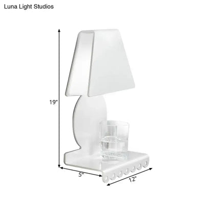 White trapezoid wall sconce with curved pedestal and glass tumbler on base on Tampa Home & Garden Store