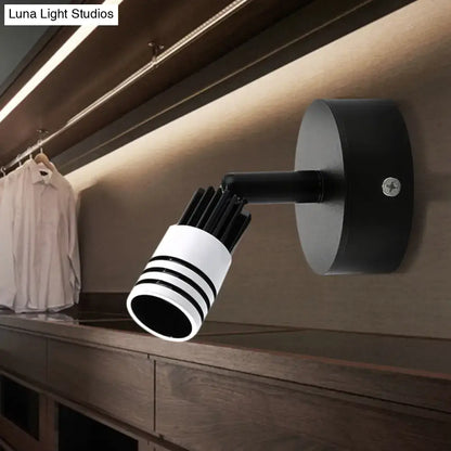 White metal wall spotlight with striped cylindrical shade on an adjustable black arm on Tampa Home & Garden Store