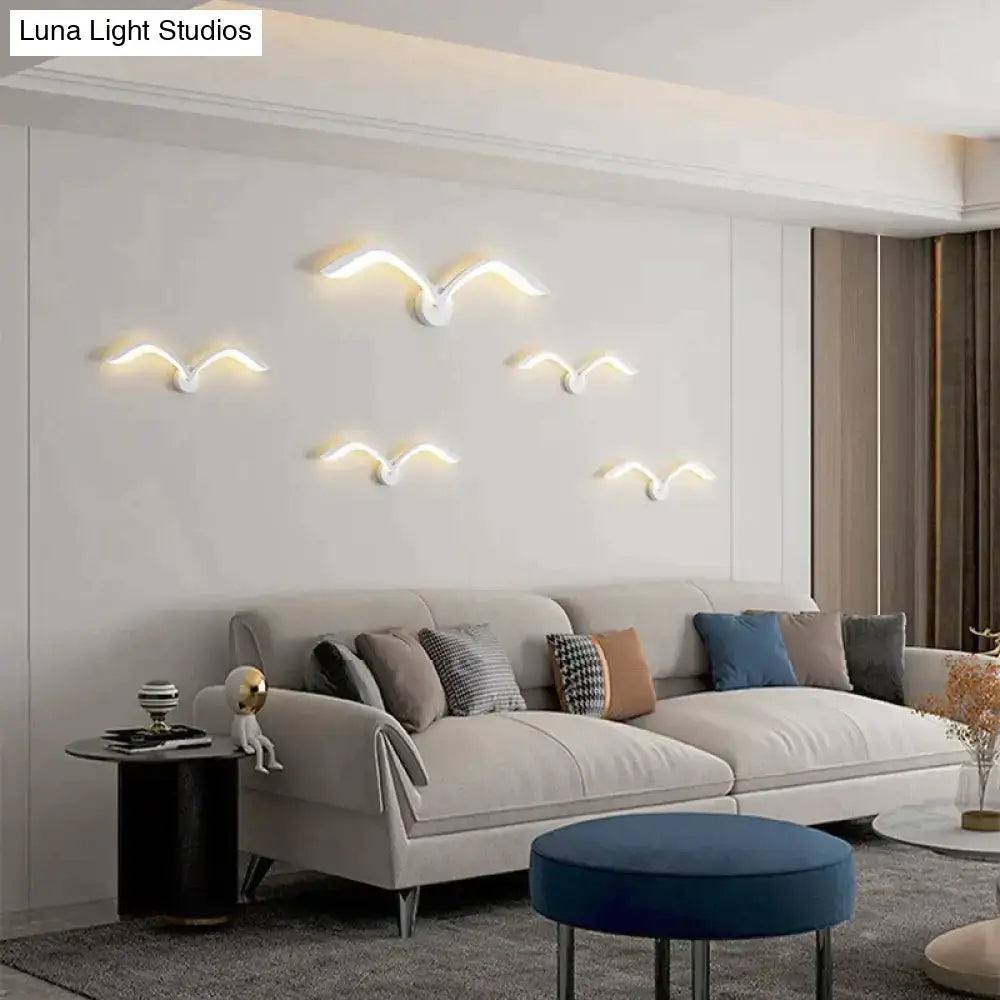White Nordic Wing Sconce wall light cluster by Decorbites in a modern living room on Tampa Home & Garden Store