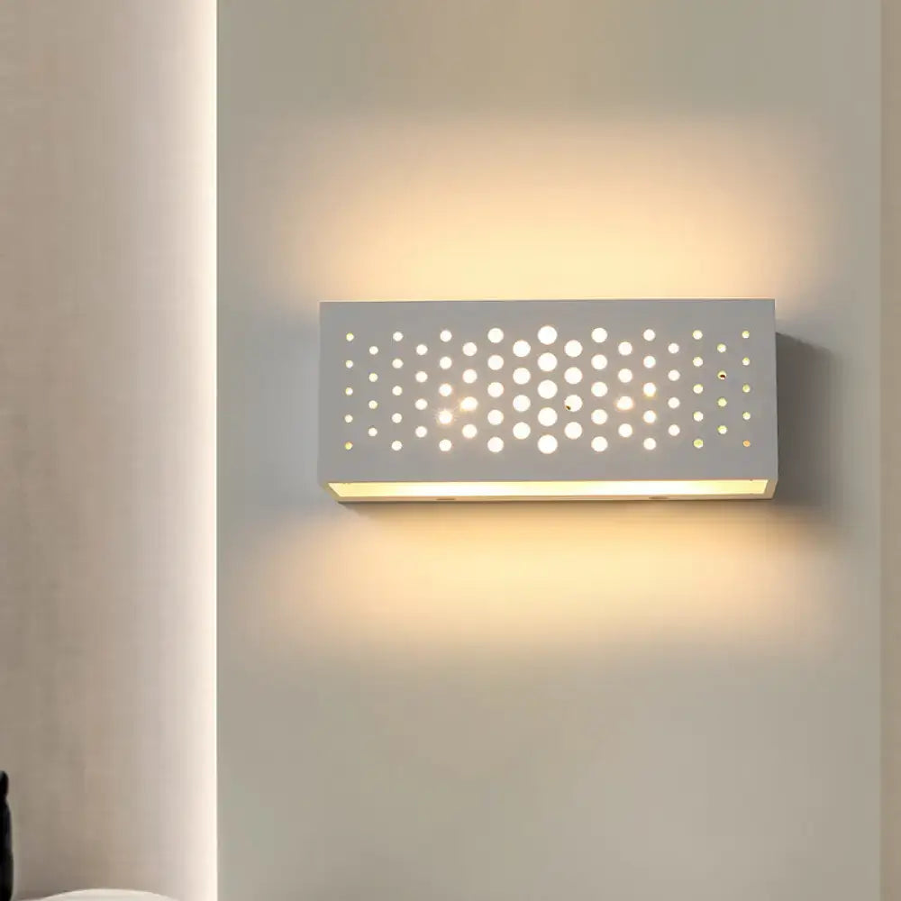 White perforated laser-cut sconce by Decorbites with warm backlit glow on Tampa Home & Garden Store