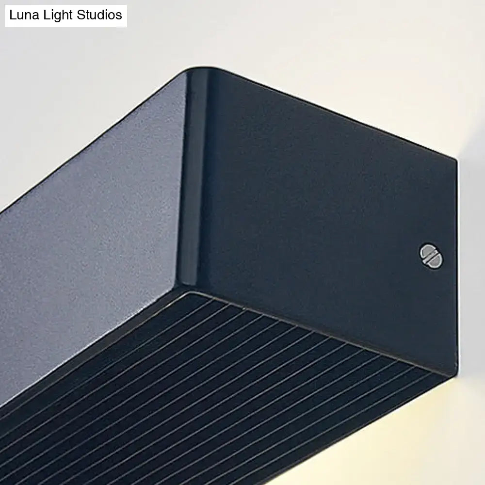 Gold rectangular wall lamp close-up in dark metal with grooved underside on Tampa Home & Garden Store