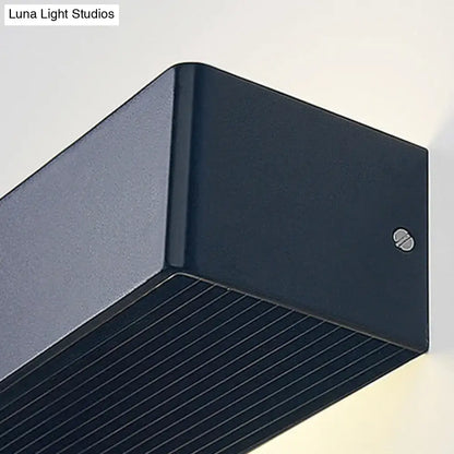 Gold rectangular wall lamp close-up in dark metal with grooved underside on Tampa Home & Garden Store