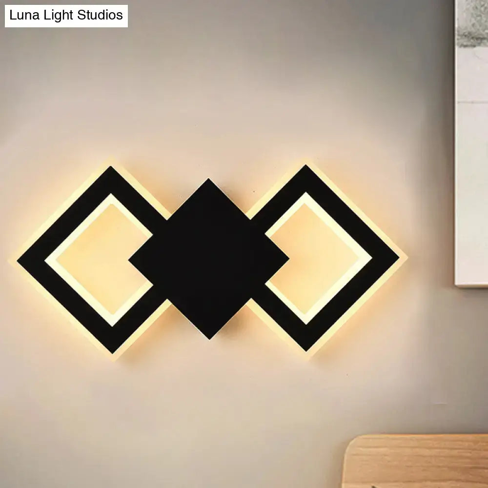 White metal LED wall sconce with diamond-frame design and warm backlit glow on Tampa Home & Garden Store