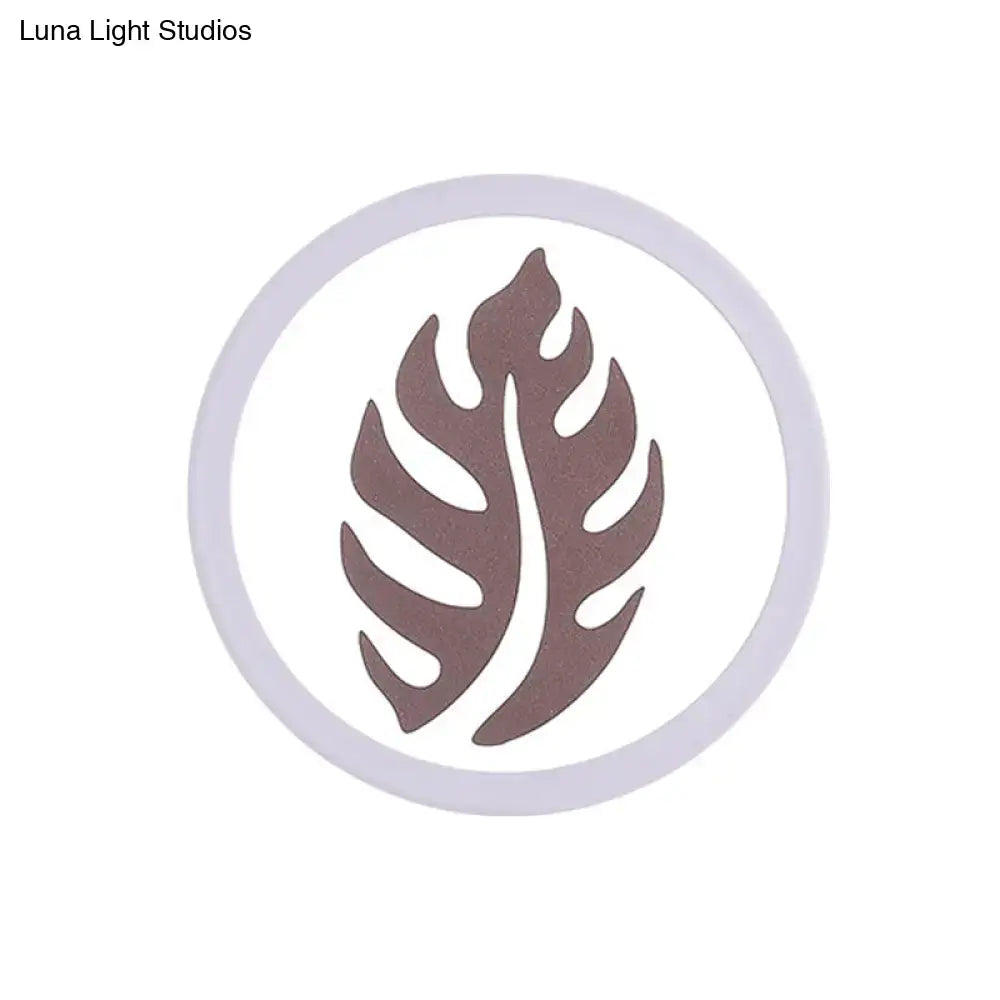White leaf wall light by Decorbites, circular frame with leaf silhouette on Tampa Home & Garden Store