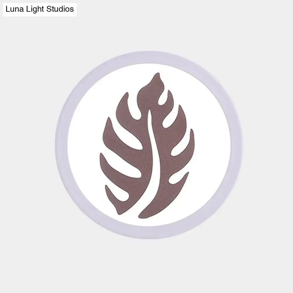 White leaf wall light by Decorbites, circular white disc with brown leaf silhouette on Tampa Home & Garden Store
