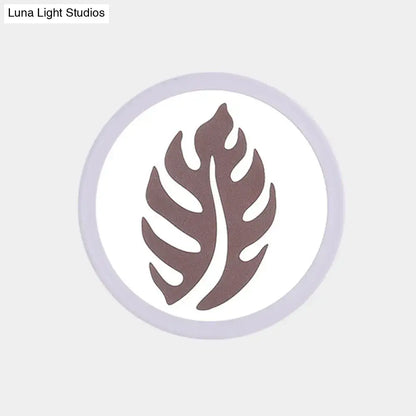 White leaf wall light by Decorbites, circular white disc with brown leaf silhouette on Tampa Home & Garden Store