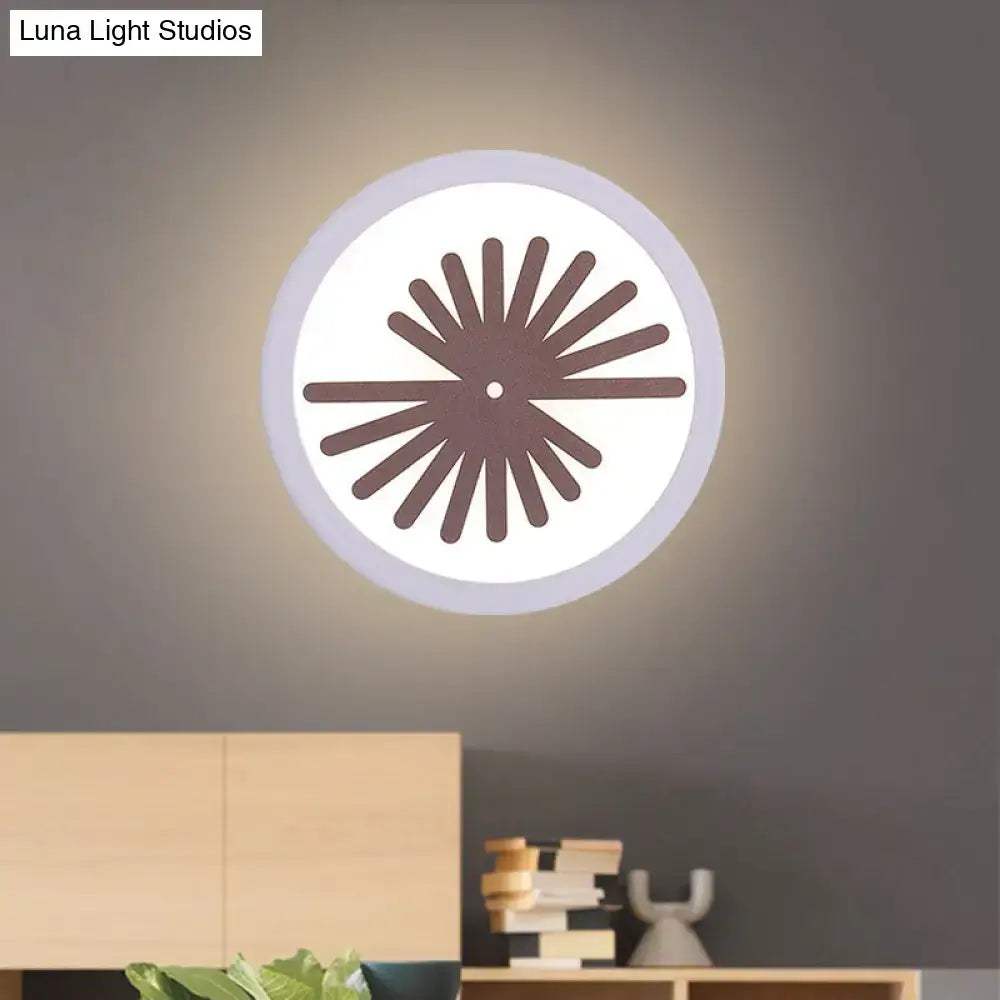 White leaf wall light Decorbites with circular shade and brown sunburst spokes on wall on Tampa Home & Garden Store