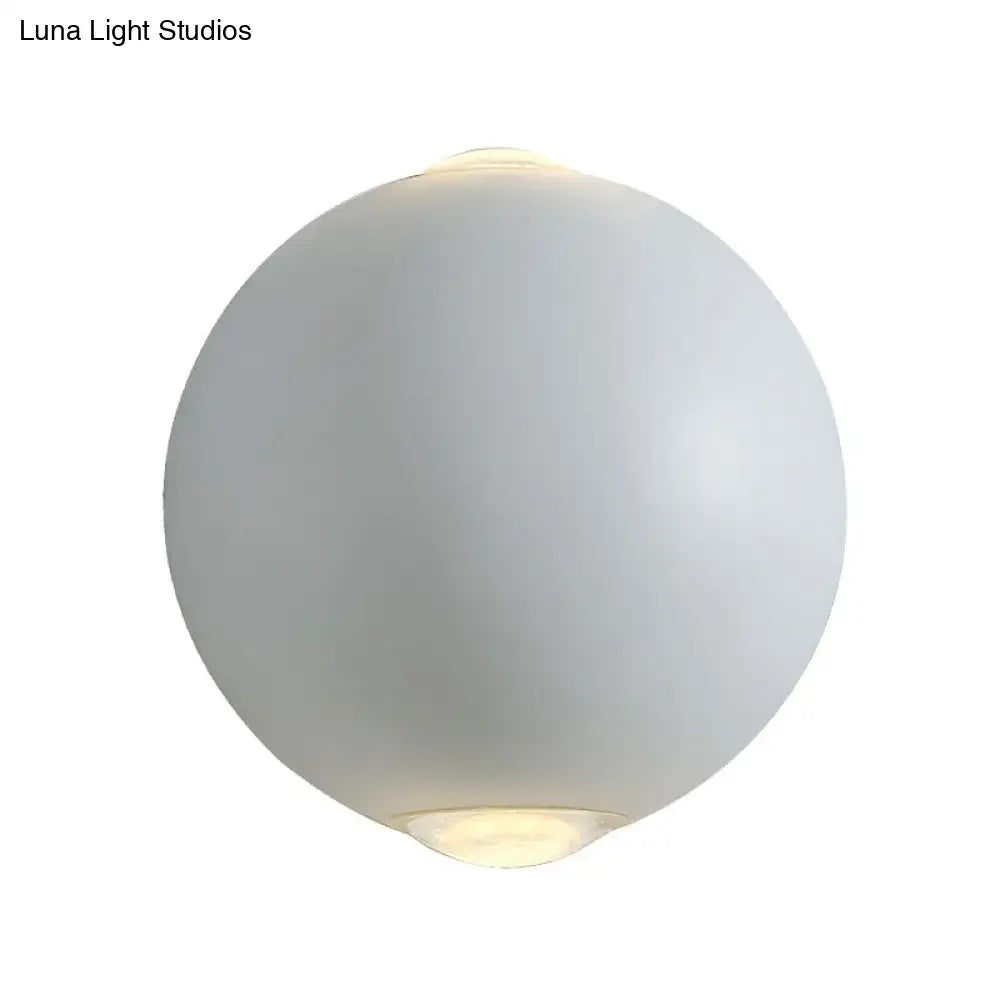 White spherical outdoor wall sconce by Decorbites with frosted globe and warm light on Tampa Home & Garden Store