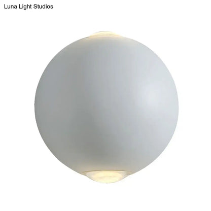White spherical outdoor wall sconce by Decorbites with frosted globe and warm light on Tampa Home & Garden Store