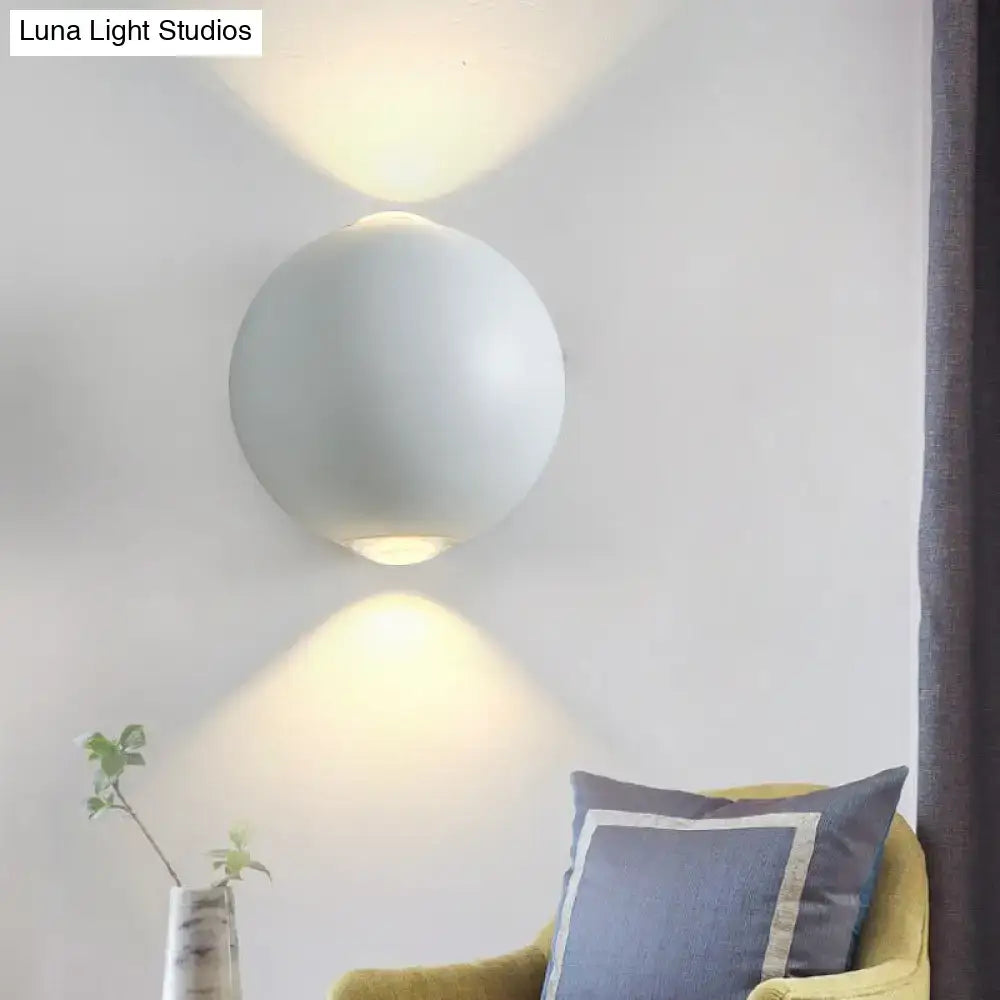 White spherical outdoor wall sconce by Decorbites with uplight and downlight on wall on Tampa Home & Garden Store