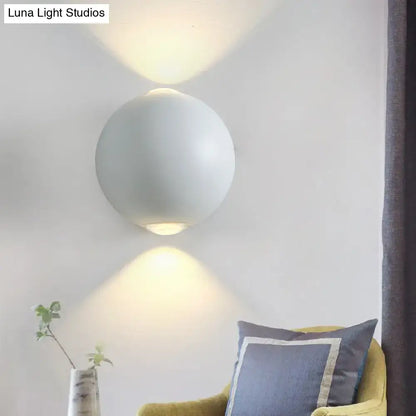 White spherical outdoor wall sconce by Decorbites with uplight and downlight on wall on Tampa Home & Garden Store