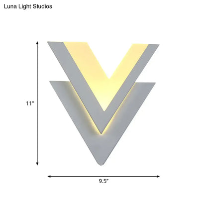 White V-shaped wall light with layered chevrons and warm backlit glow; 11in tall, 9.5in wide on Tampa Home & Garden Store