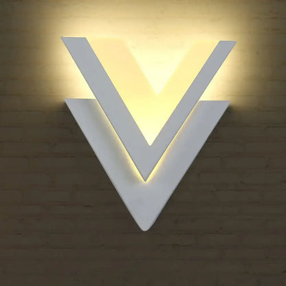 White V-shaped wall light by Decorbites, modern LED wall lamp with warm backlighting on Tampa Home & Garden Store