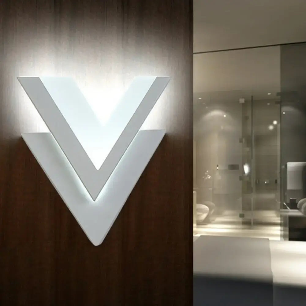 White V-shaped LED sconce by Decorbites on dark wood wall, modern home & garden wall light on Tampa Home & Garden Store