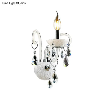 White crystal wall light by Decorbites with hanging crystal prisms and a candle-style bulb on Tampa Home & Garden Store