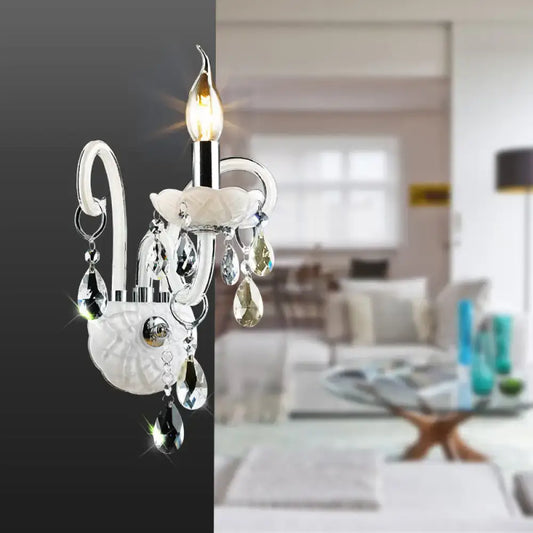 Decorbites white crystal wall light sconce with hanging prisms and flower accent, candle bulb on Tampa Home & Garden Store