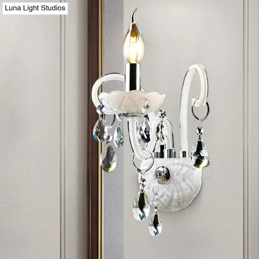 White crystal wall light sconce with dangling prisms and candle-shaped bulb by Decorbites on Tampa Home & Garden Store