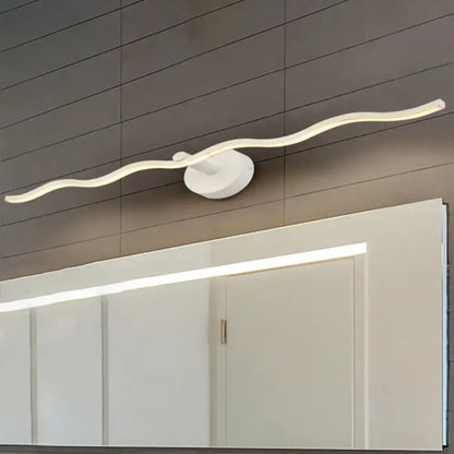 White Wave Vanity Light, Decorbites curved LED fixture on round wall mount above a mirror on Tampa Home & Garden Store