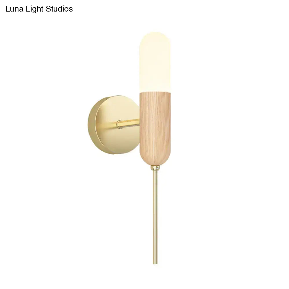 Brass wood sconce with frosted cylindrical glass shade and wood body on Tampa Home & Garden Store