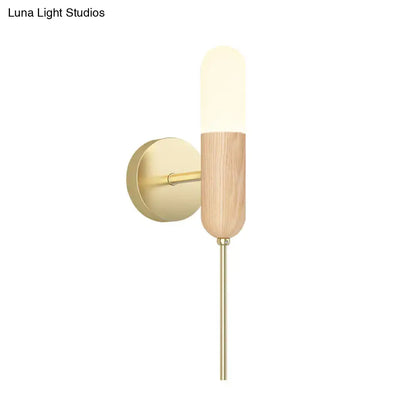Brass wood sconce with frosted cylindrical glass shade and wood body on Tampa Home & Garden Store