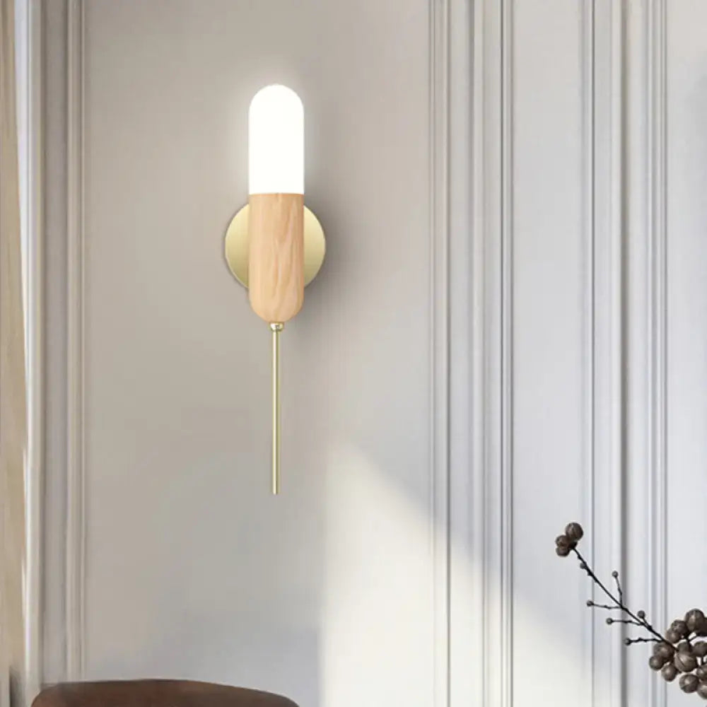 Brass wood glass shade sconce by Decorbites with cylindrical white glass atop a wood body on Tampa Home & Garden Store